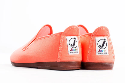 Javer Pair of orange slip-on shoes with visible brand labels on a white background