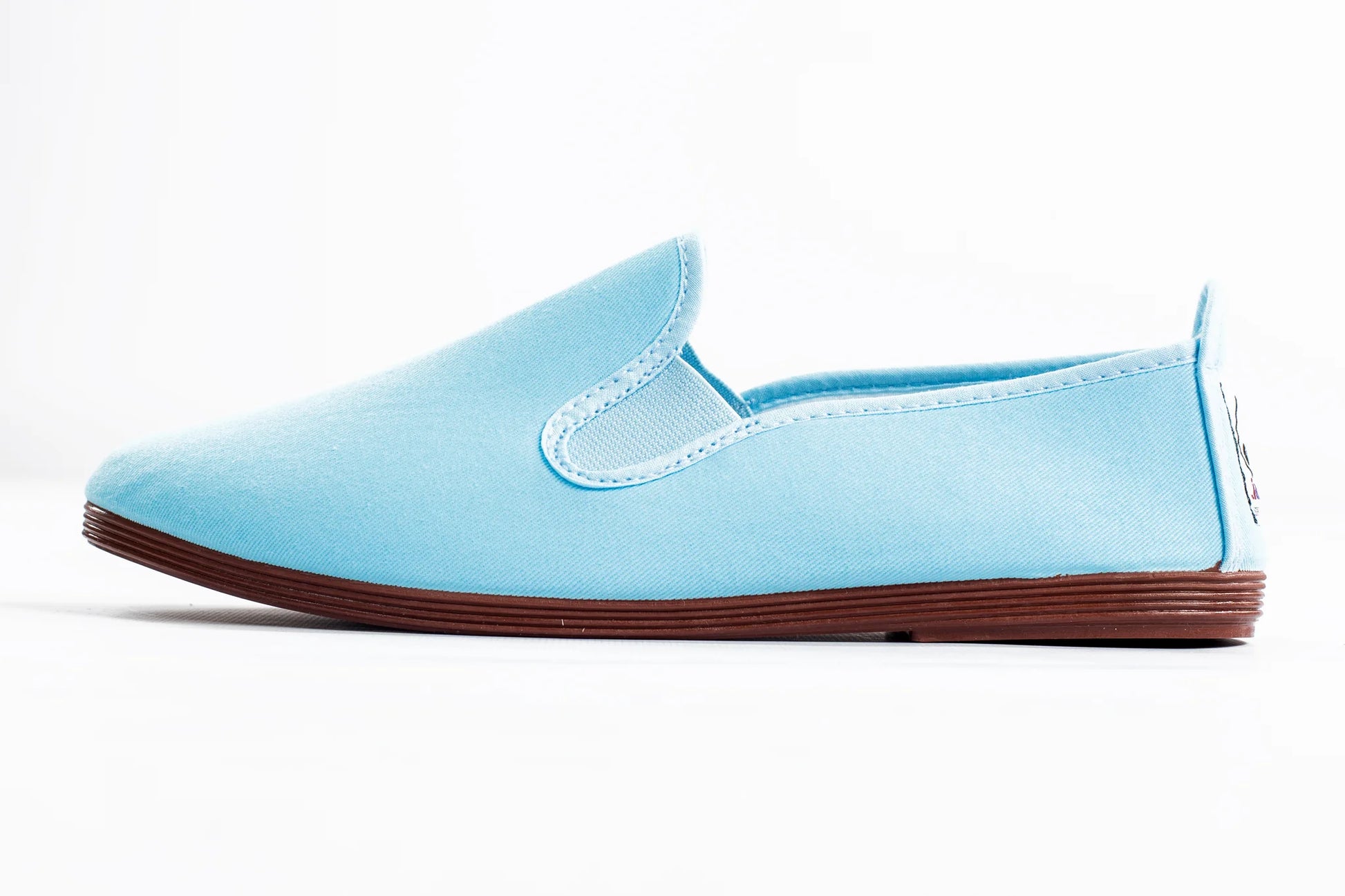 Javer Light blue slip-on shoe with brown sole on a white background