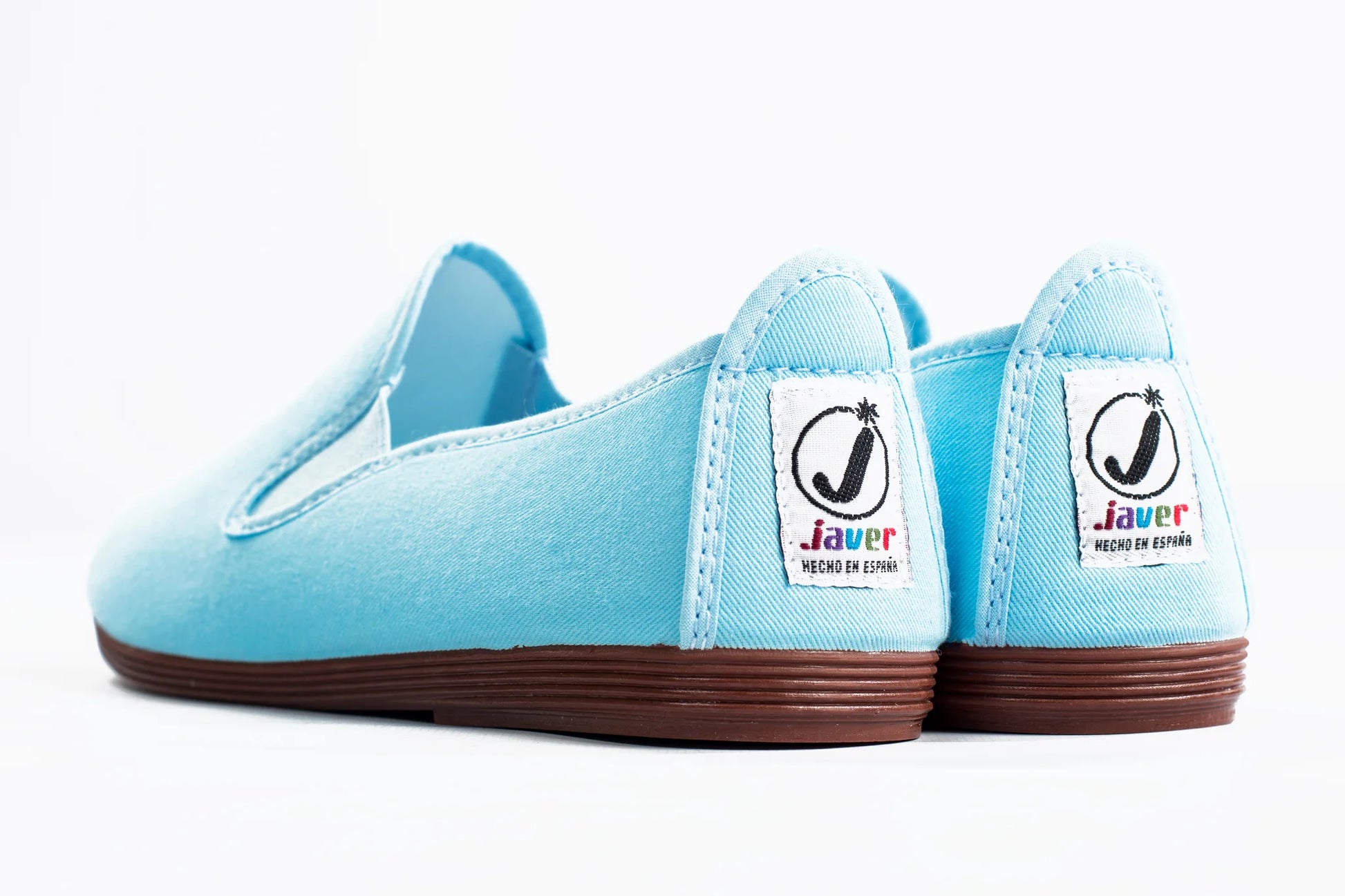 Javer Light blue slip-on shoes with brown soles on a white background