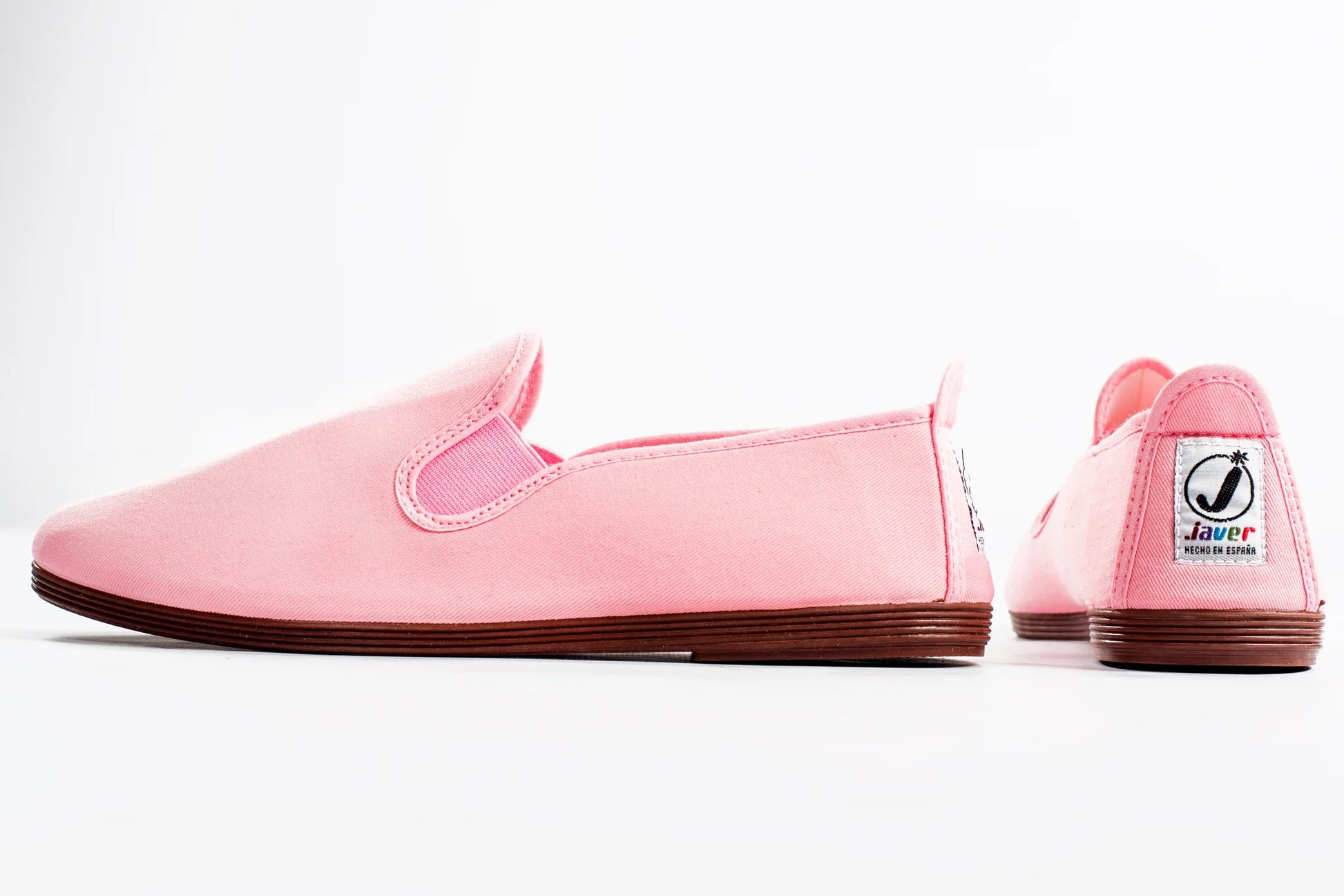 Pink Javer slip-on shoes with a brand logo on a white background