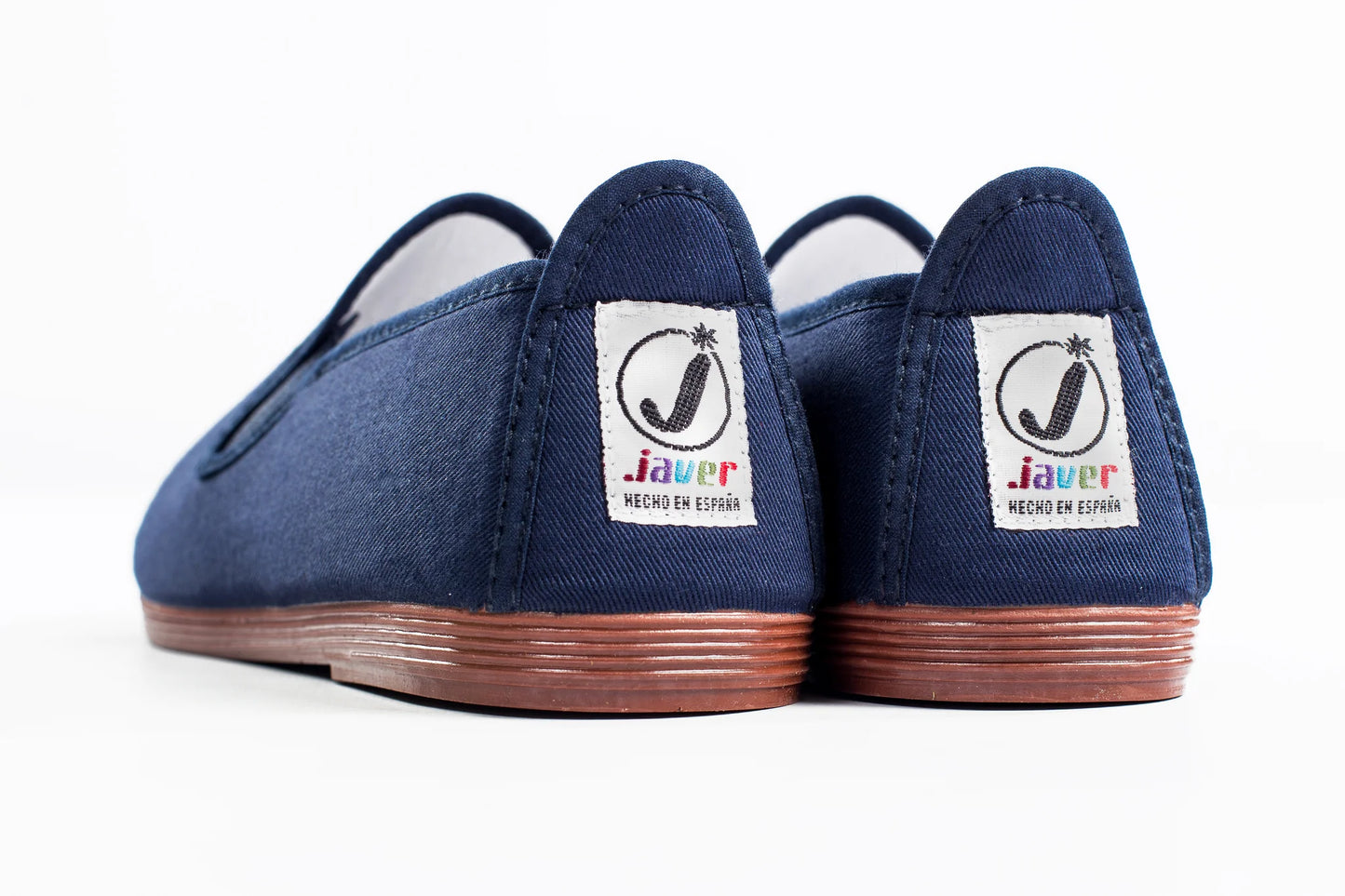 Javer Pair of blue slip-on shoes with 'Javer' branding on a white background