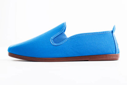Javer Blue slip-on shoe with brown sole on a white background