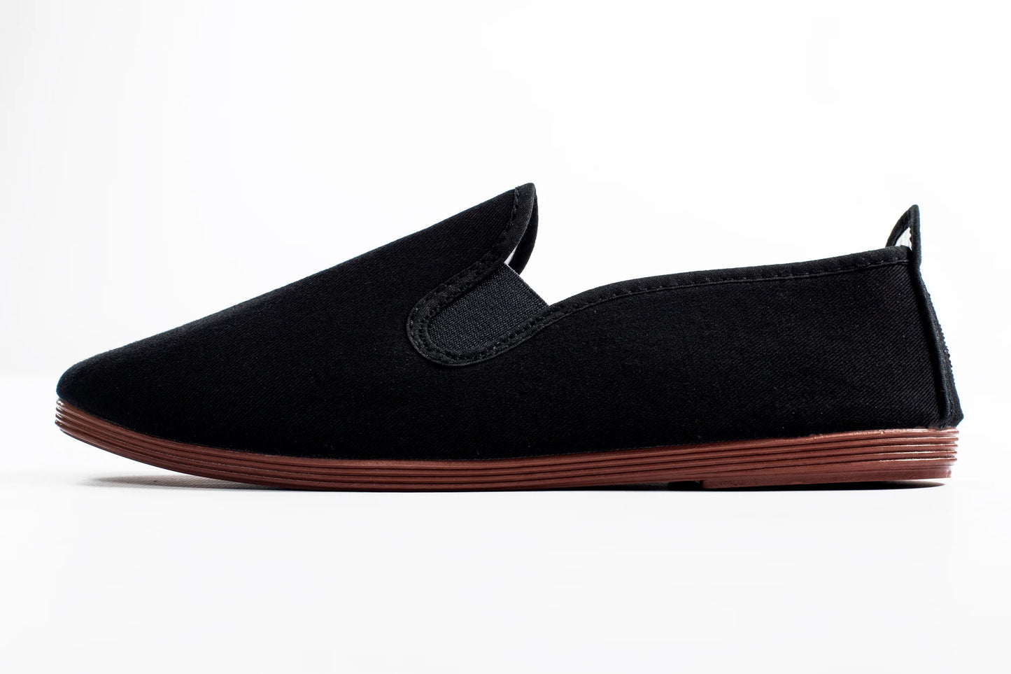 Javer Black slip-on shoe with brown sole on a white background