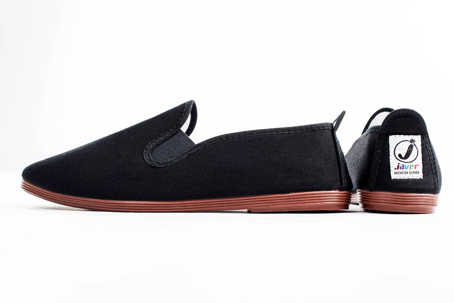Javer Black slip-on shoes with brown soles on a white background