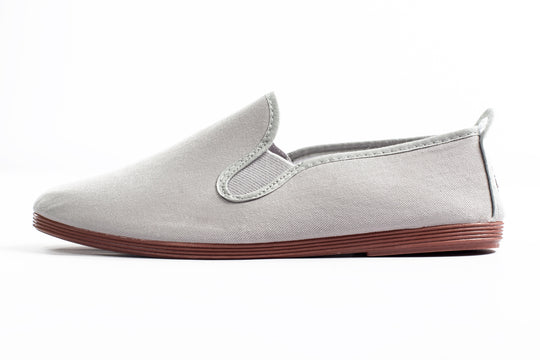 Javer White slip-on shoe with red sole on a white background