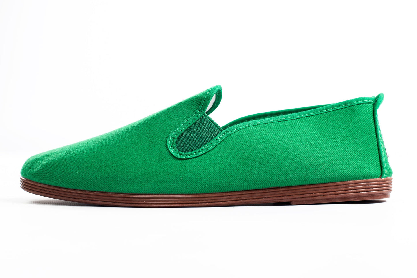 Javer Green slip-on shoe with brown sole on a white background