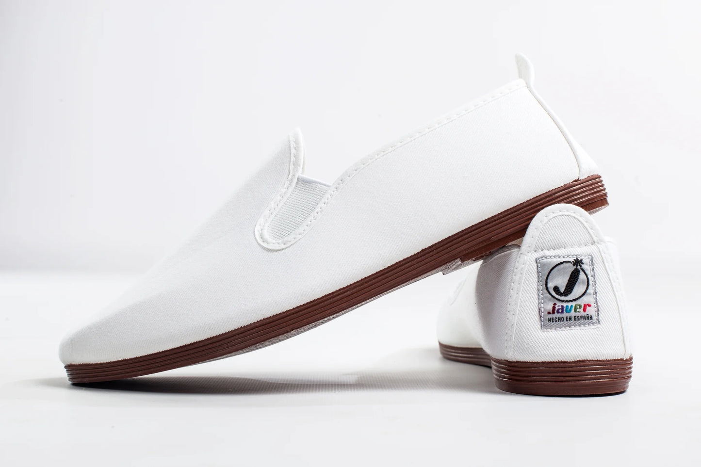 Javer White shoes with brown soles on a white background