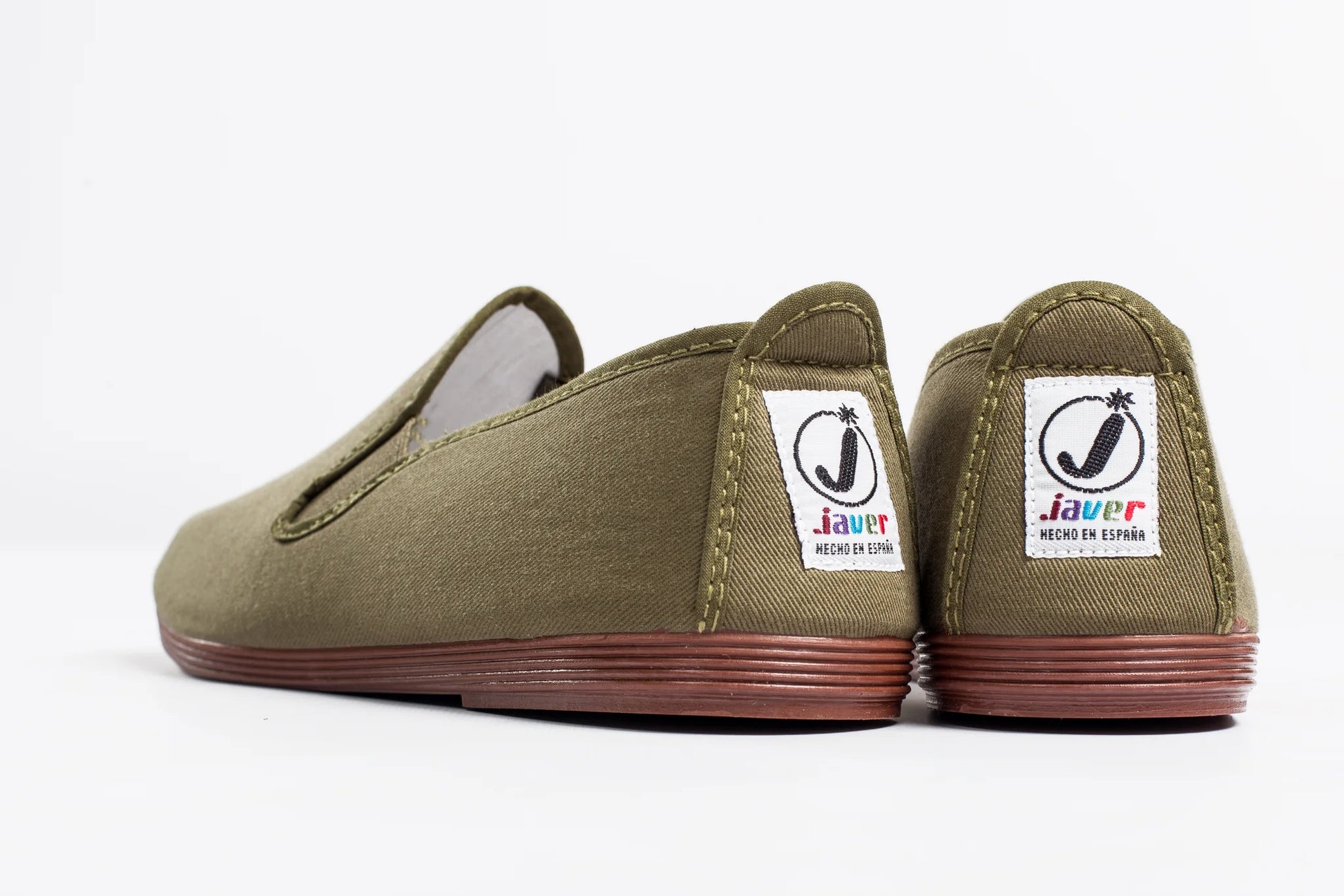 Pair of olive green slip-on shoes with visible brand label on a white background by Javer 
